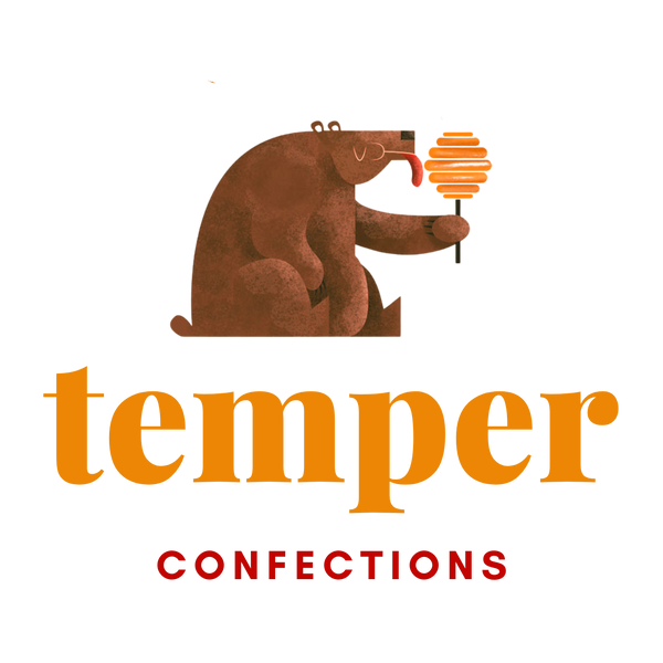 Logo for Temper Confections including a cute brown bear sitting and licking a lollipop.